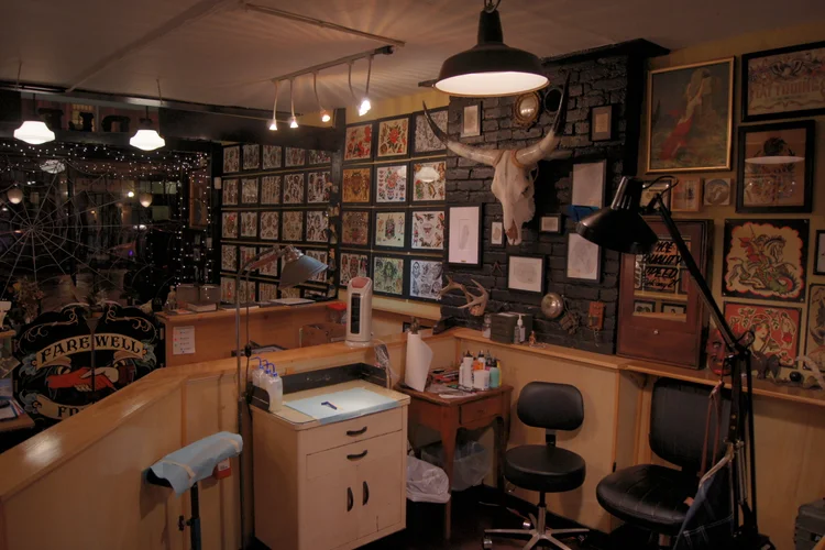 Tattoo station with flash art covering the walls