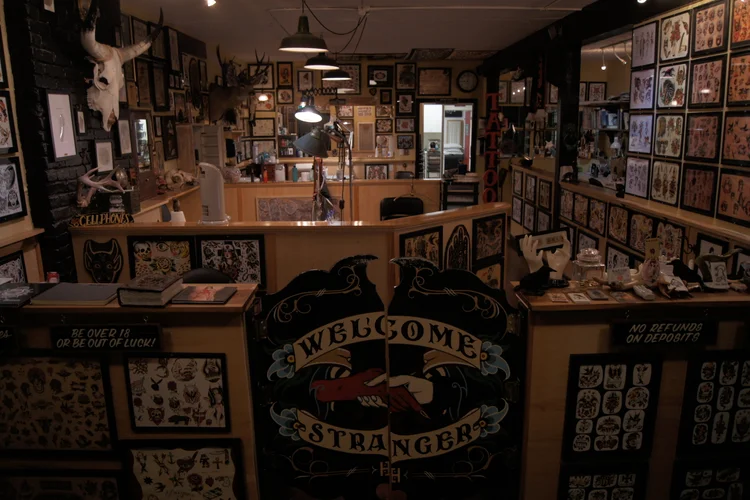 Welcome Stranger painted gate and flash-covered interior